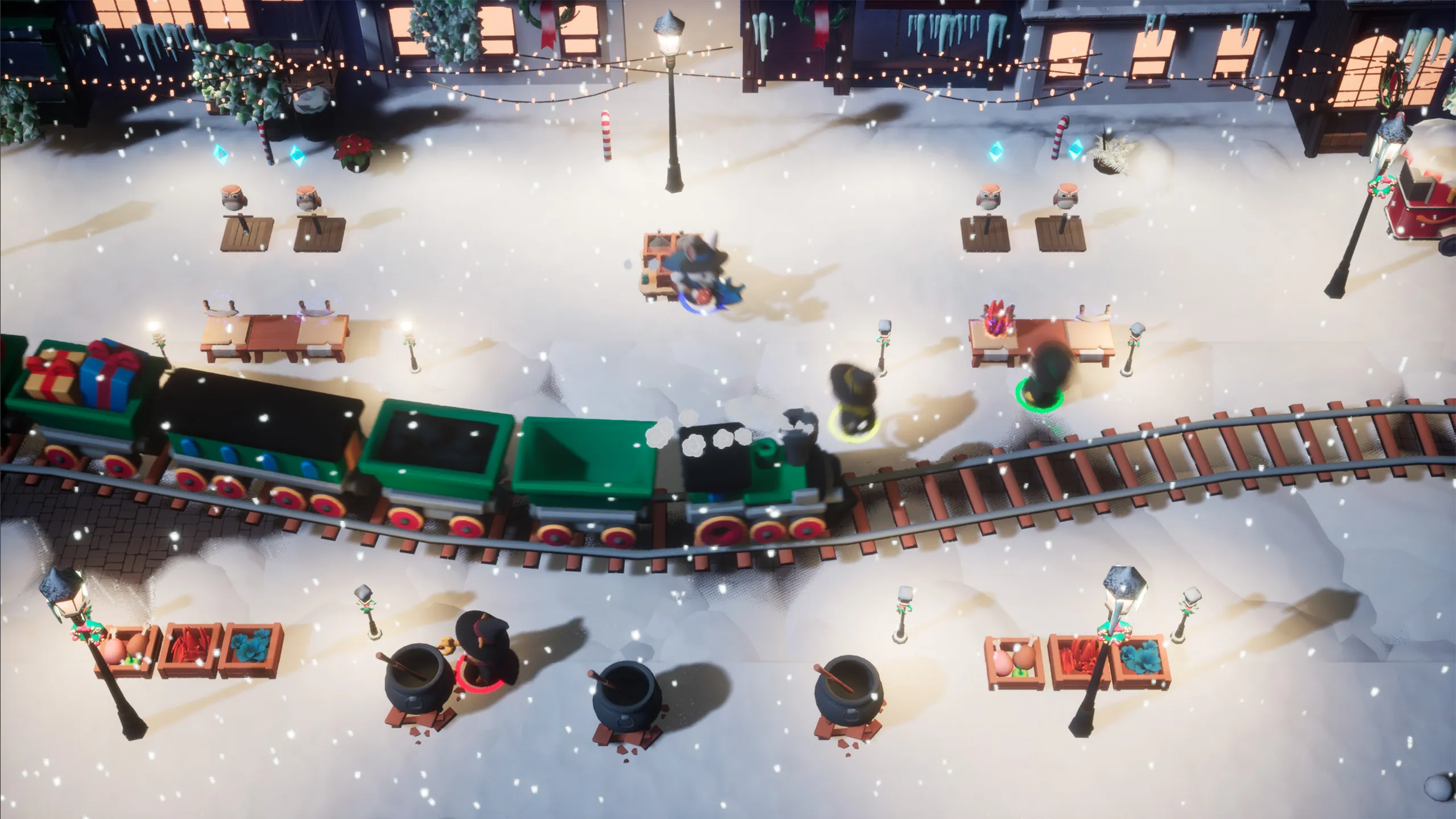 A snowy town plaza at night strung with lights, where a train runs straight through the wizards’ cauldrons and ingredient crates.